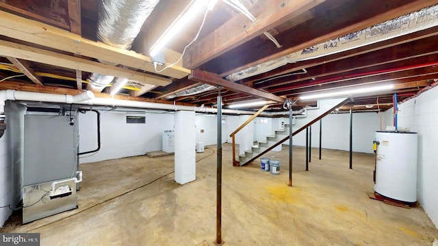 basement with washer / dryer, water heater, and heating unit