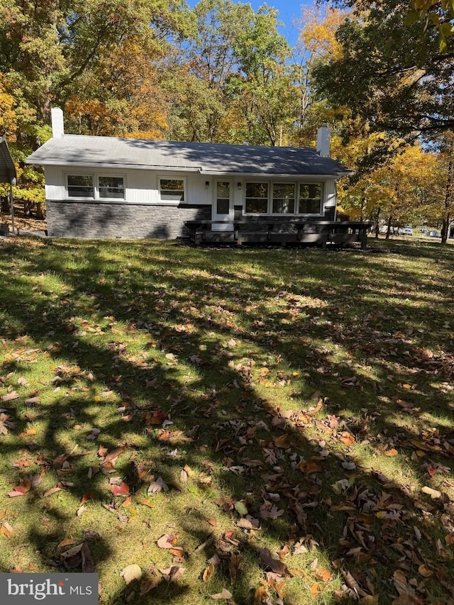 rear view of house with a yard