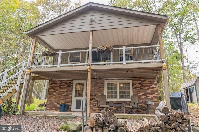 rear view of property with a patio and a balcony