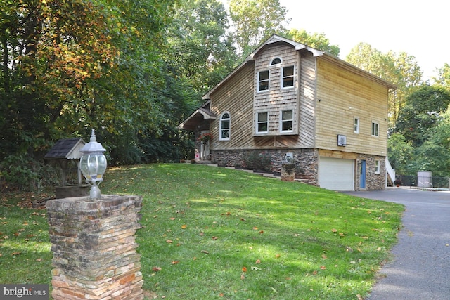 view of property exterior featuring a lawn and a garage