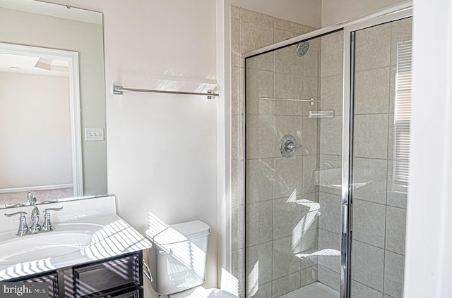 bathroom featuring walk in shower, vanity, and toilet