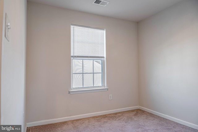 spare room with light colored carpet