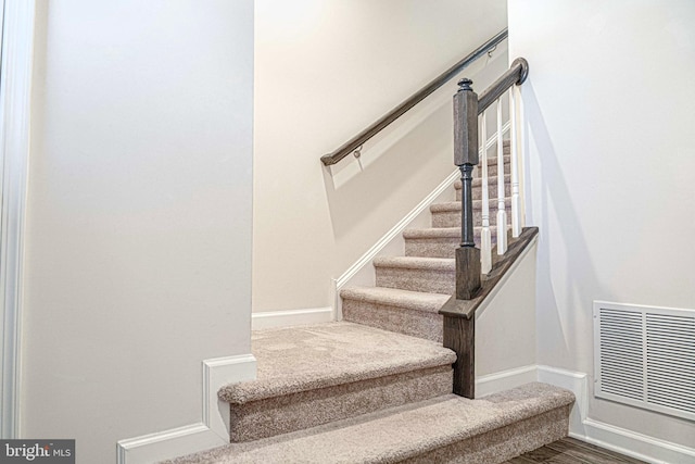 staircase featuring hardwood / wood-style flooring