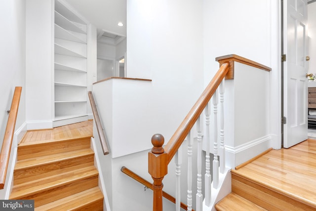 stairway with hardwood / wood-style floors