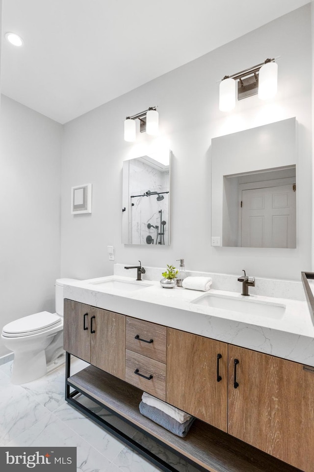 bathroom with vanity, a shower, and toilet