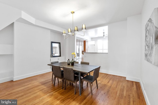 dining room with a chandelier and light hardwood / wood-style flooring