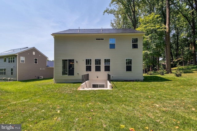 rear view of house featuring a yard