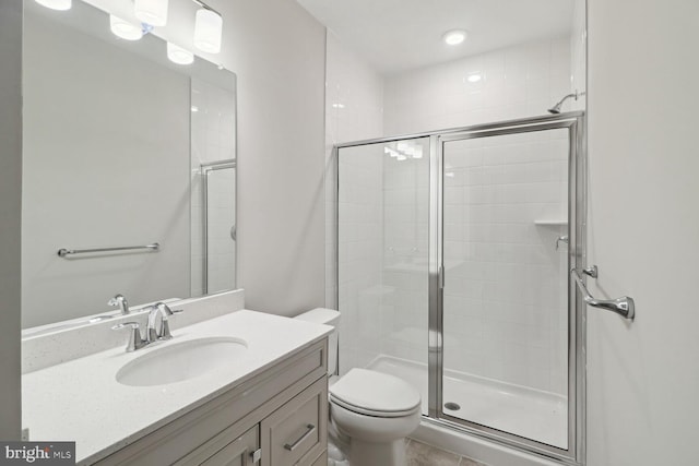 bathroom with vanity, toilet, and an enclosed shower