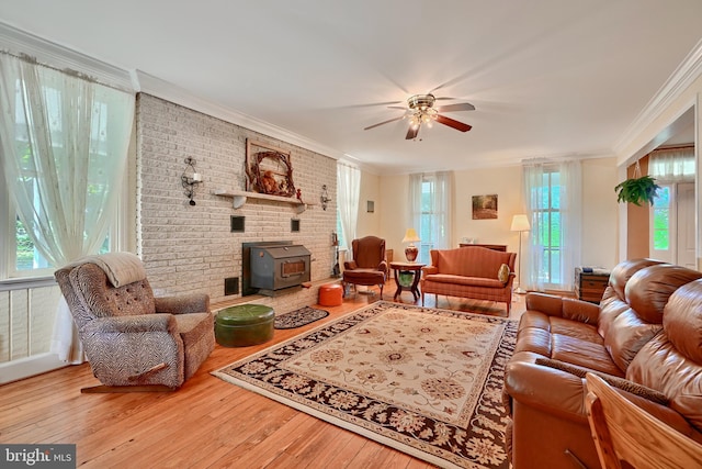 living room featuring ornamental molding, hardwood / wood-style flooring, and ceiling fan