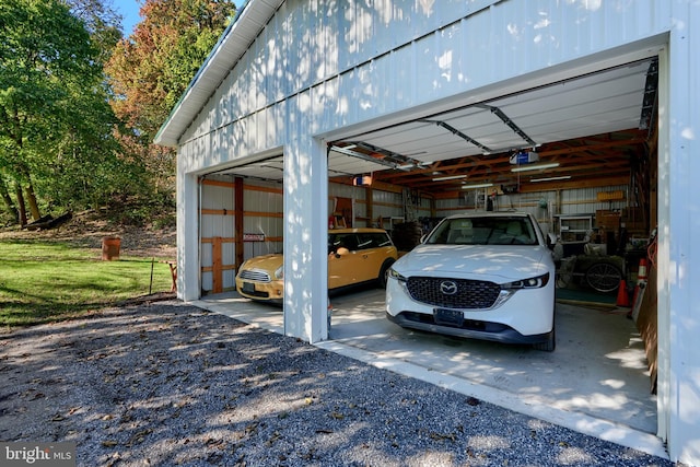 garage with a garage door opener and a yard