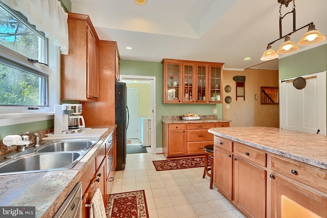 kitchen with decorative light fixtures, sink, dishwasher, ornamental molding, and black refrigerator