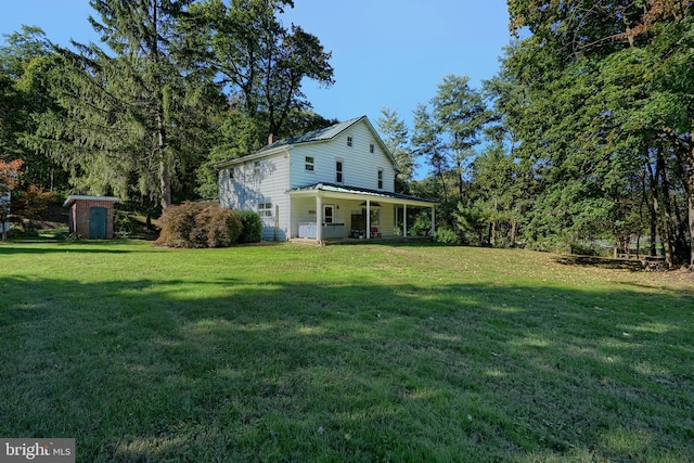 view of yard with a porch and a storage shed