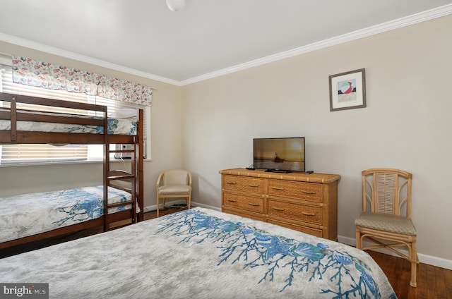 bedroom with ornamental molding and dark hardwood / wood-style floors