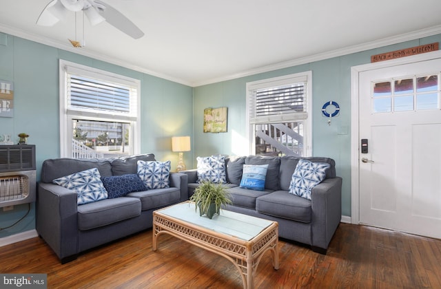 living room with heating unit, crown molding, dark hardwood / wood-style flooring, and ceiling fan