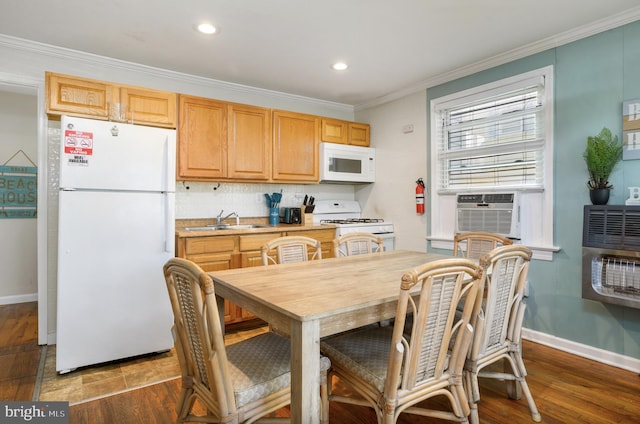 kitchen featuring white appliances, dark wood-type flooring, sink, decorative backsplash, and ornamental molding