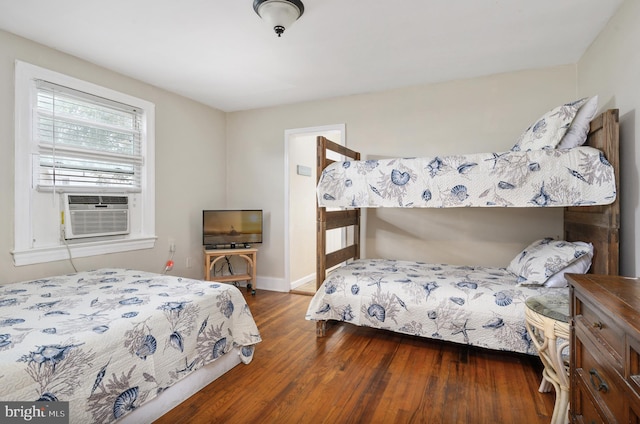 bedroom featuring cooling unit and dark hardwood / wood-style floors