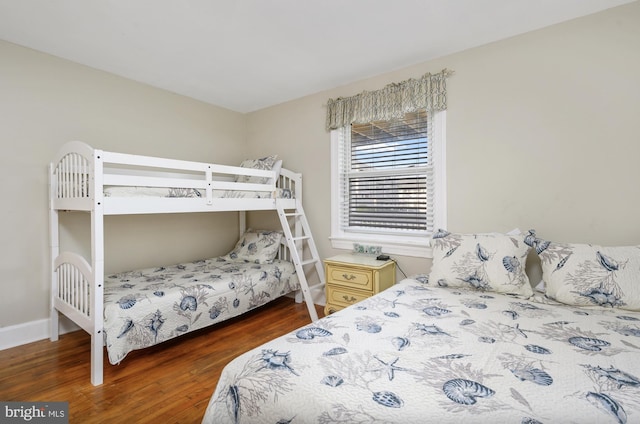 bedroom with dark wood-type flooring