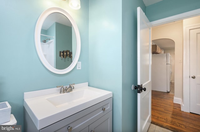 bathroom featuring hardwood / wood-style flooring, toilet, and vanity