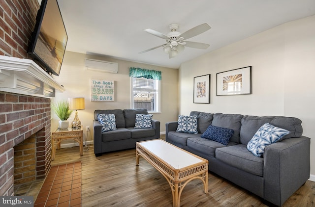 living room with ceiling fan, hardwood / wood-style flooring, a fireplace, and a wall unit AC