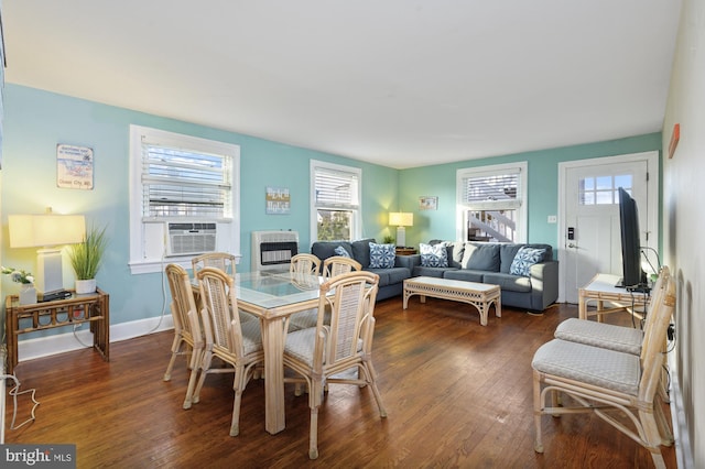 dining space featuring heating unit, dark hardwood / wood-style floors, and cooling unit