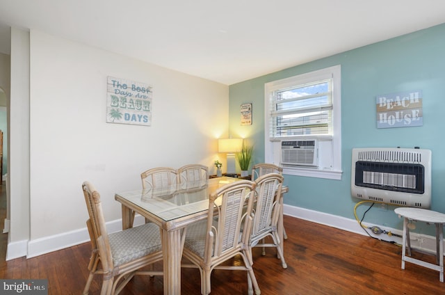 dining room featuring cooling unit, dark hardwood / wood-style floors, and heating unit