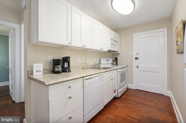 kitchen featuring dark hardwood / wood-style floors, sink, white appliances, and white cabinetry