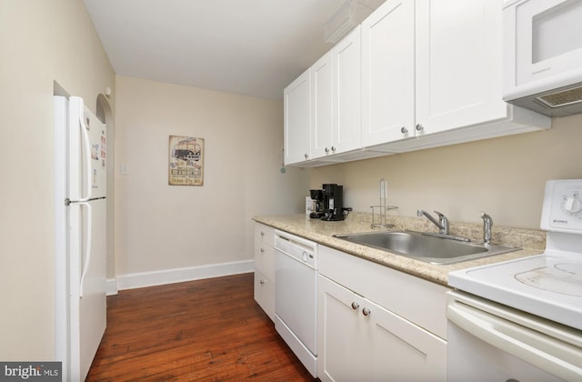 kitchen featuring sink, white appliances, white cabinetry, and dark hardwood / wood-style floors