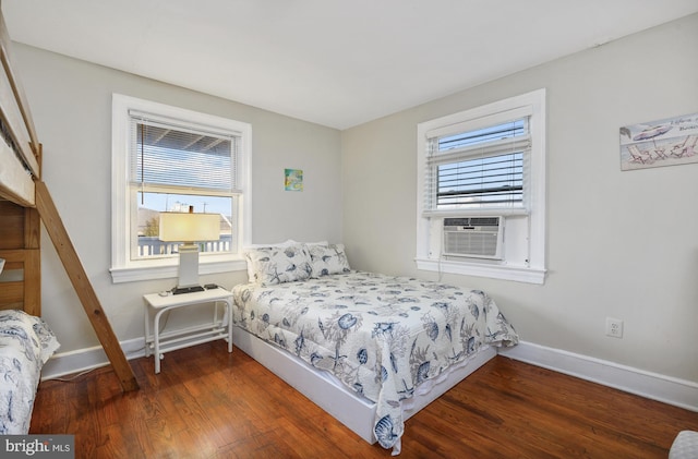 bedroom featuring multiple windows, cooling unit, and dark hardwood / wood-style floors