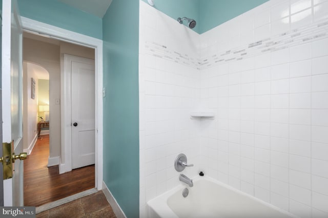 bathroom featuring hardwood / wood-style floors and tiled shower / bath combo