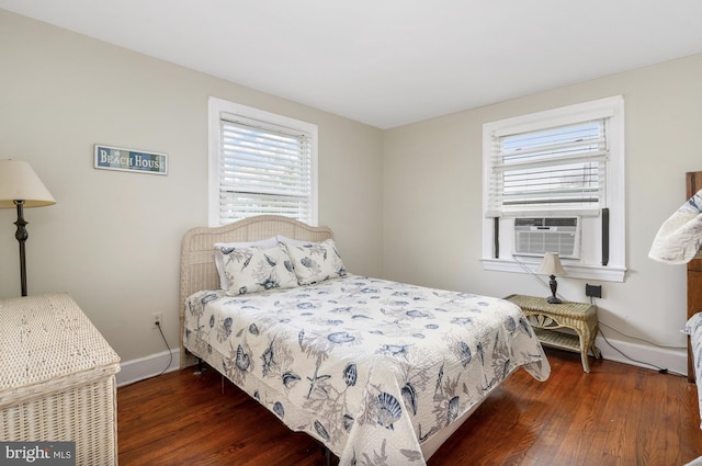 bedroom featuring cooling unit and dark wood-type flooring