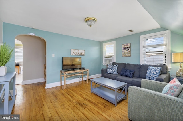 living room with light wood-type flooring and lofted ceiling