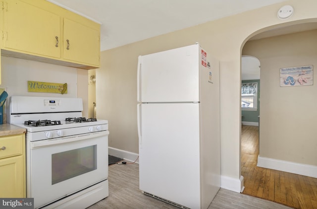 kitchen featuring light wood-type flooring and white appliances