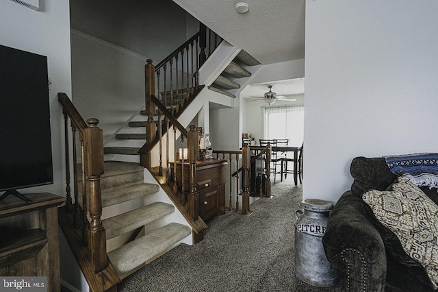 staircase with carpet, a textured ceiling, and ceiling fan