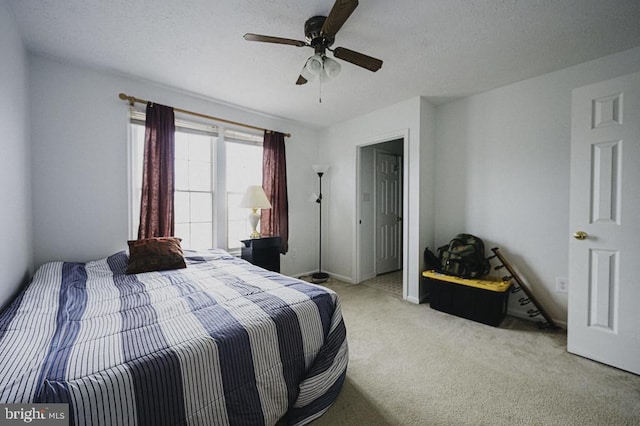 bedroom featuring ceiling fan and light carpet