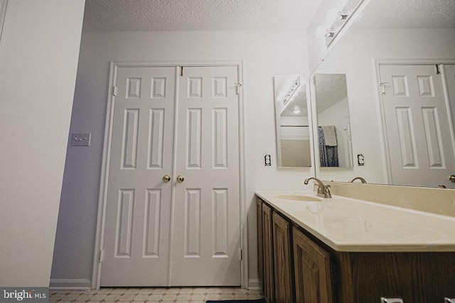 bathroom featuring vanity and a textured ceiling