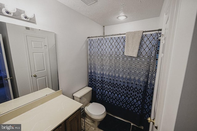 bathroom featuring vanity, a shower with curtain, a textured ceiling, and toilet