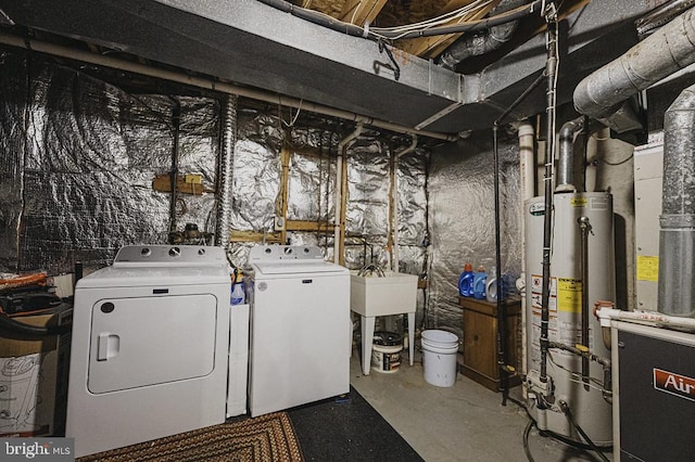 interior space with washing machine and dryer and water heater