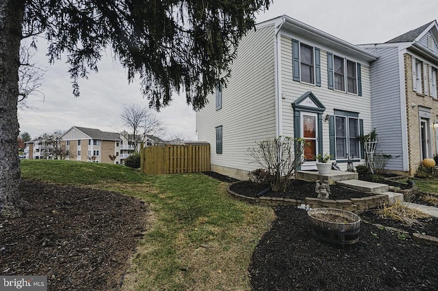 view of side of home featuring a lawn