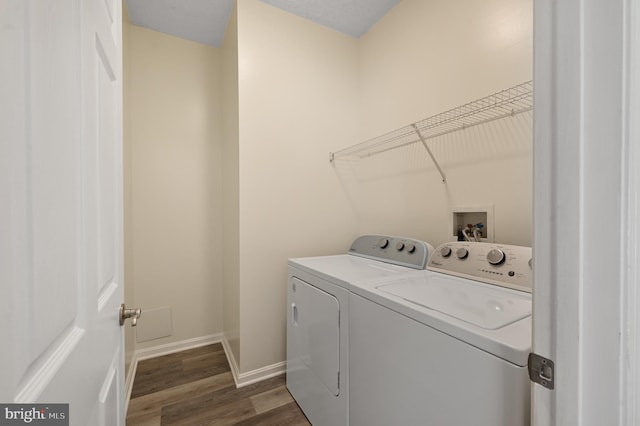 washroom with independent washer and dryer and dark hardwood / wood-style flooring