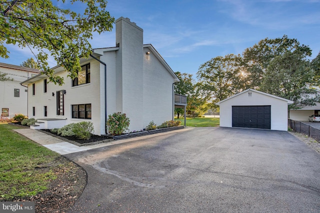 view of side of property with an outdoor structure and a garage