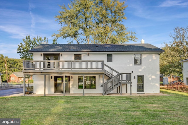 back of house featuring a deck, a yard, and a patio area