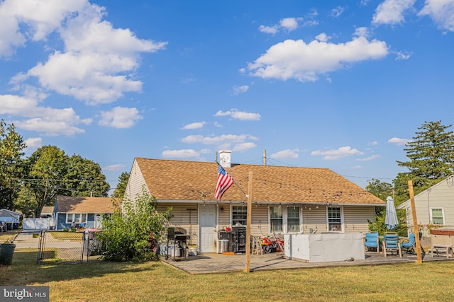 back of house featuring a yard and a patio area