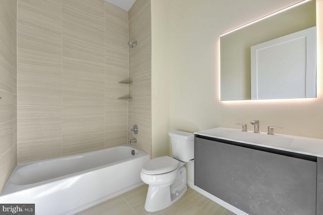 full bathroom with tile patterned flooring, tiled shower / bath combo, toilet, and vanity