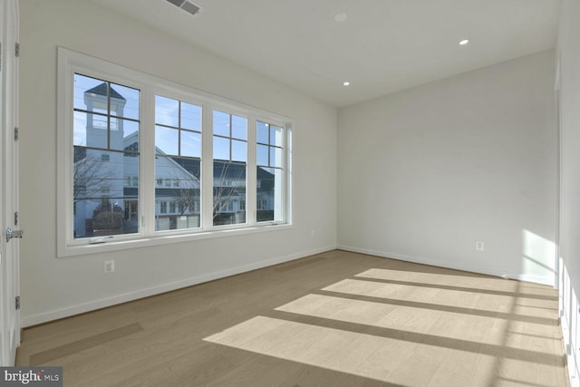 unfurnished room with wood-type flooring