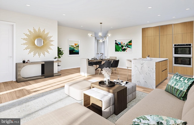 living room featuring light hardwood / wood-style flooring and an inviting chandelier