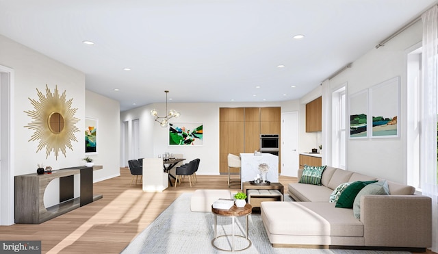 living room featuring light hardwood / wood-style floors and a chandelier