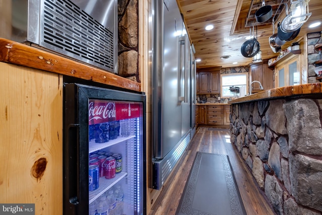 kitchen with high end refrigerator, wooden ceiling, and dark hardwood / wood-style flooring