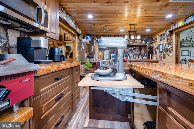 kitchen featuring wood ceiling, hardwood / wood-style flooring, and butcher block countertops