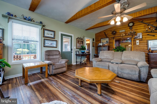 living room featuring vaulted ceiling with beams, wooden walls, wood-type flooring, and ceiling fan