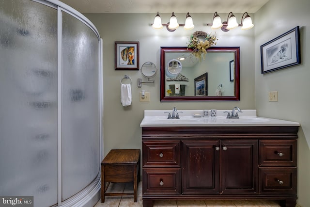 bathroom featuring vanity, a shower with shower door, and tile patterned floors